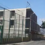 Real estate investment projects in Tbilisi: View of multi-story investment building under construction in Avlabari, Tbilisi with adjacent sports court and scaffolding