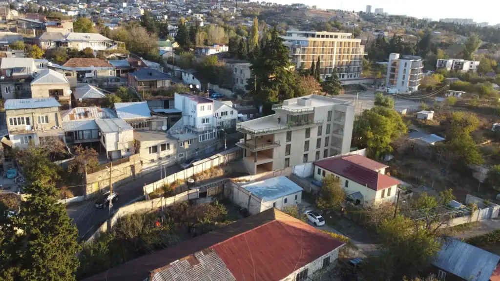 Avlabari Hill investment property in Tbilisi with modern concrete facade – aerial angle view by LD Estates.