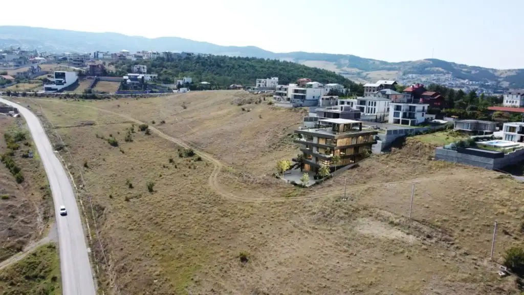 Real estate investment in Georgia - Panoramic view of a modern apartment building and investment land