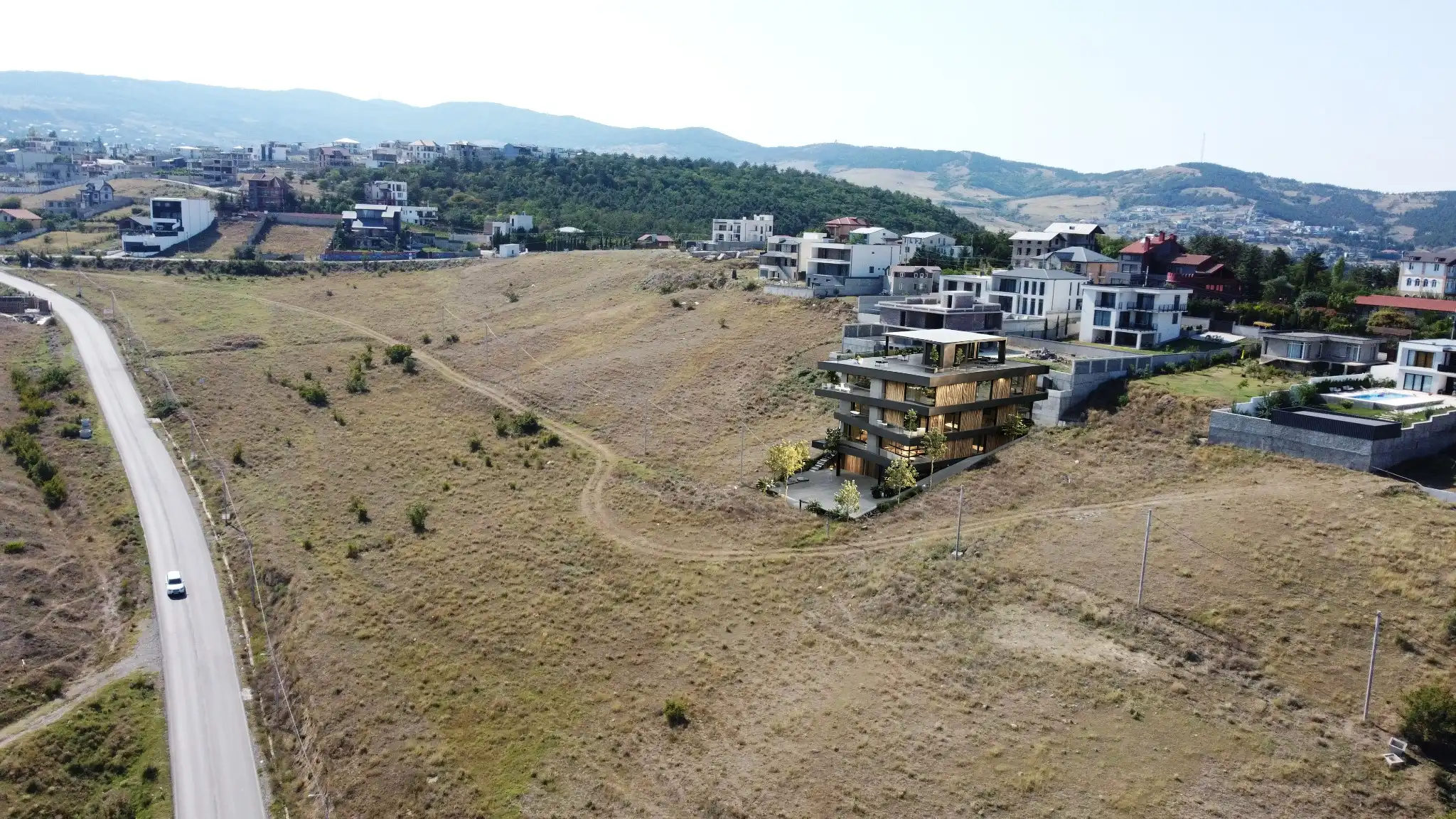 Real estate investment in Georgia - Panoramic view of a modern apartment building and investment land