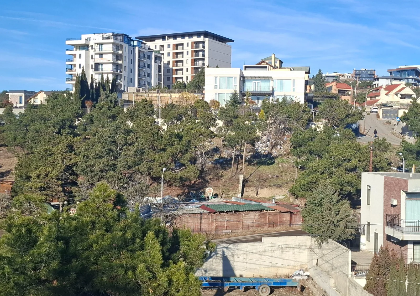 Current condition of the Lisi Lake development site in context, showing the secured parcel and surrounding area